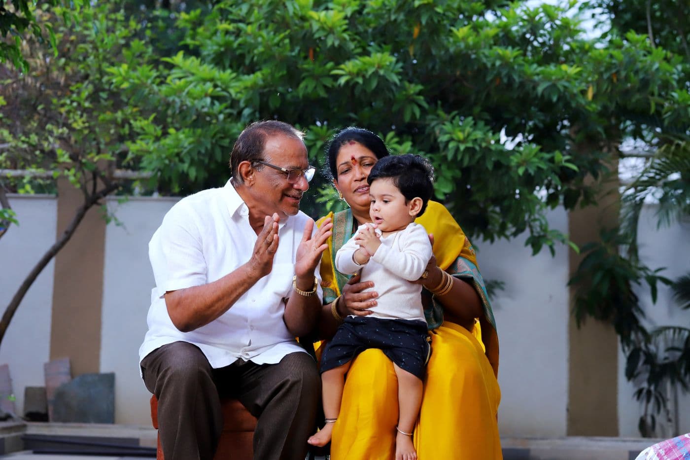Grandparents, parents and a child together at home
